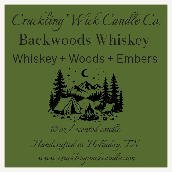 Backwoods Whiskey candle with forest camping label and 'Crackling Wick Candle Co.'