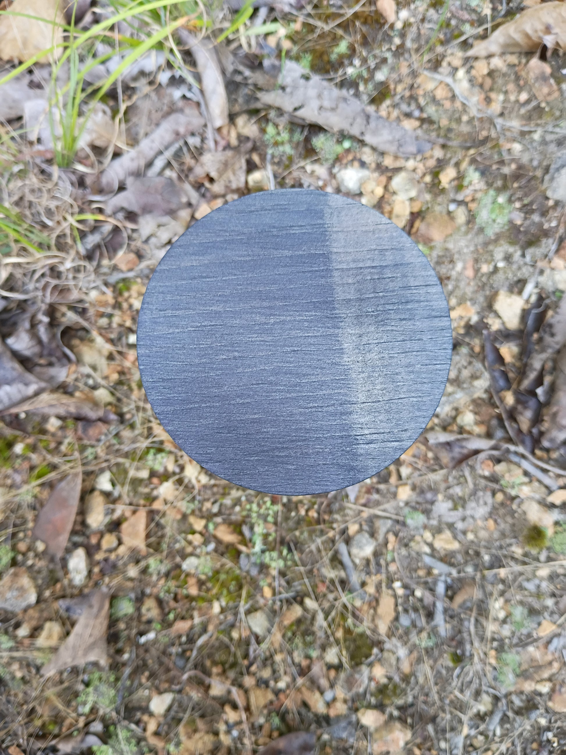 Round dark wax candle top with small wick tab