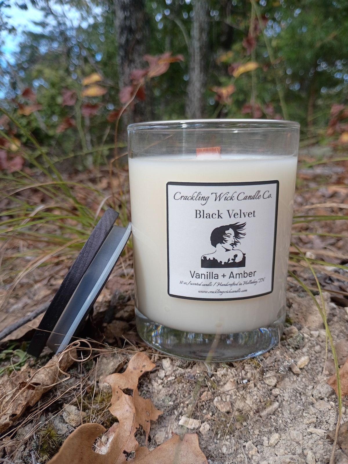 Glass jar candle with "Black Velvet" label, white wax, visible wick