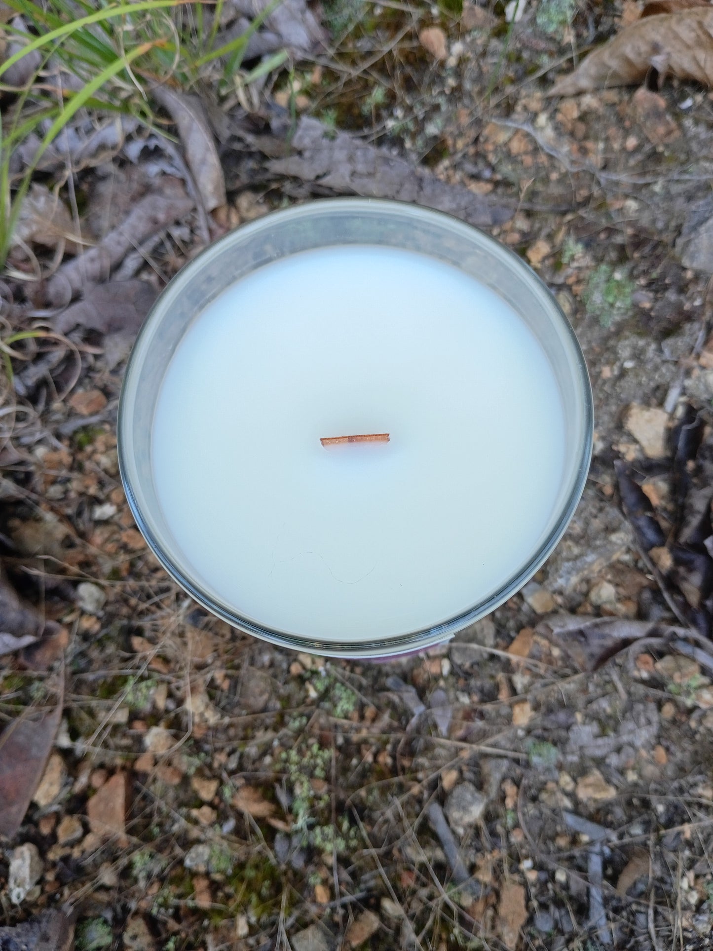 Glass candle jar top with pale wax and centered wick