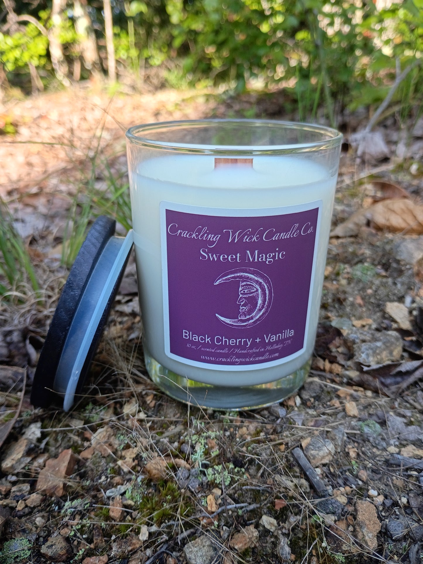 Glass jar candle with purple label for Black Cherry and Vanilla
