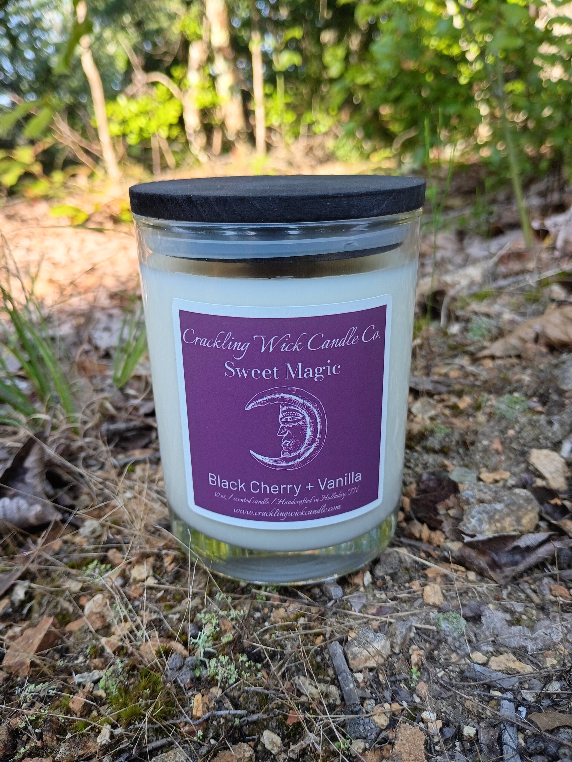 Glass jar candle with black lid and purple Black Cherry + Vanilla label