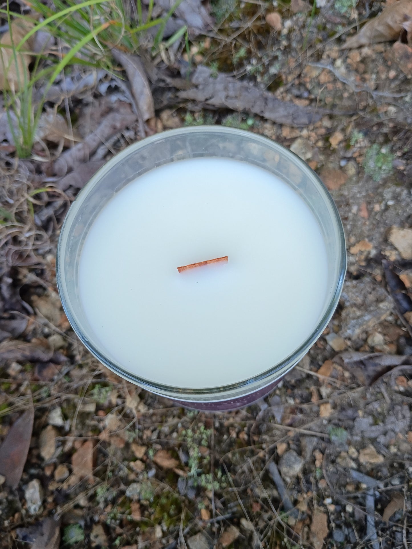White wax candle in metal tin with exposed wick
