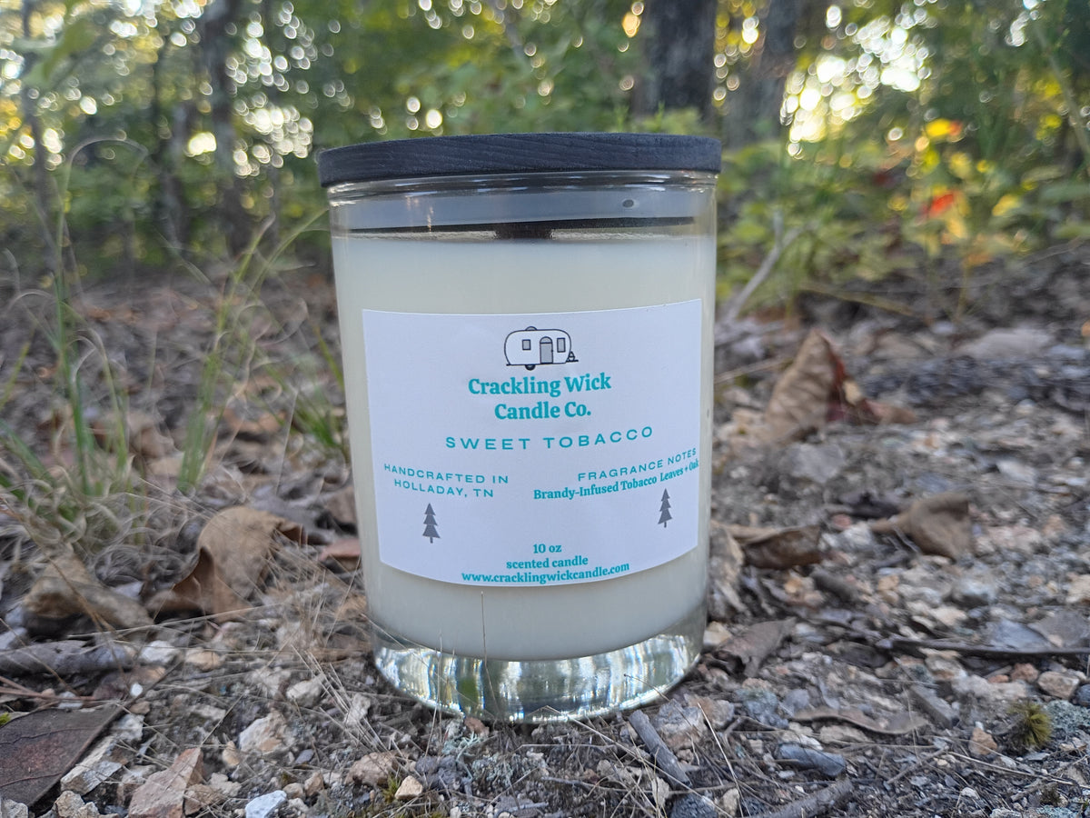 Glass jar candle with black lid, Sweet Tobacco label, and clear base